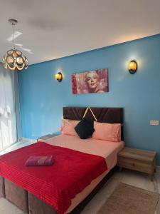a bedroom with a large bed with a red blanket at Very beautiful apartment with see view 5th in Casablanca