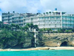 CupecoyTranquil Oceanside: Pools & Direct Beach Access的海边悬崖上的酒店