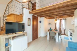 a living room with a large television and a table with chairs at Casa Corallo in Palau