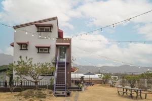 a house with a staircase up to it with lights at Gongju Simpyeongjae Private House Pension in Gongju
