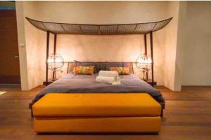 a bedroom with a large bed with a canopy at Tranquil lake view villa on Phuket golf estate in Kathu