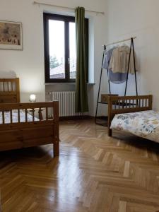 a bedroom with two beds and a window at La casa di Dora in Buttigliera Alta +11 photos