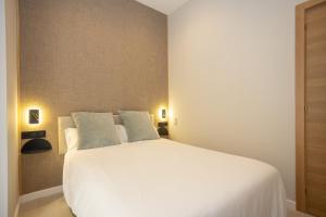 Posteľ alebo postele v izbe v ubytovaní Chinitas Urban Rooms
