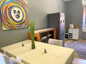 a dining room with a table and a refrigerator at Dogliola Monastery - B&B Hilltop Ocean View in Dogliola