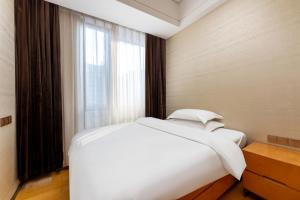 Postel nebo postele na pokoji v ubytování VanHao Serviced Apartment-Zhujiang Newtown-Near the US consulate-Vaperse the same building