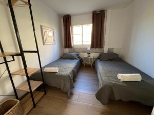 a room with two beds and a window at Dalt Vila Salou Deluxe in Salou