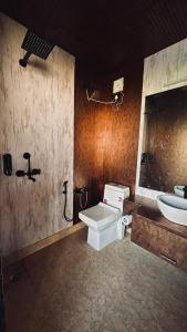a bathroom with a toilet and a sink at We Are Made Of Stories in Joshīmath