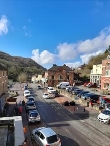 a city street with cars parked in a parking lot at Ironbridge town apartment in Ironbridge +20 photos