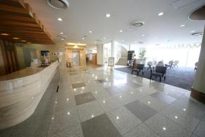 a lobby with a reception desk and chairs in a building at Kokumin Shukusha Marine Terrace Ashiya in Kitakyushu +23 photos
