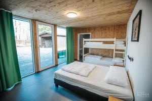 a bedroom with two bunk beds and large windows at Le Noir Flohay 30 pers - Malmedy, vue, wellness in Malmedy