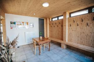 a room with a table and a wooden wall at Le Noir Flohay 30 pers - Malmedy, vue, wellness in Malmedy