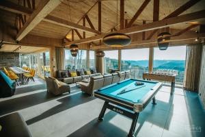 a billiard room with a pool table in the middle at Le Noir Flohay 30 pers - Malmedy, vue, wellness in Malmedy
