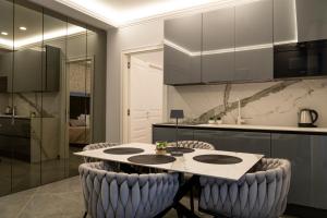 a kitchen with a table and some chairs at Amabile Luxury Rooms in SantʼAntonio Abate