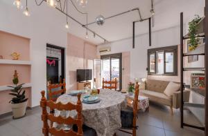 a living room with a table and a couch at THENa in Hersonissos