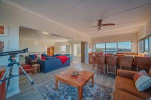 a living room with a camera on a tripod at Sapphire Sea View in Jeffreys Bay