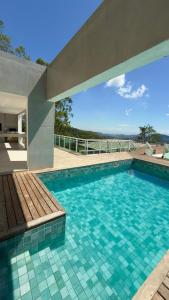 a swimming pool with a bench in a house at Mansão da Montanha in Niterói