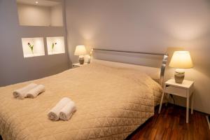 a bedroom with a bed with two towels on it at Rataskaevu 6 Apartment in Tallinn