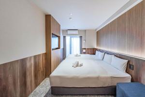 Postel nebo postele na pokoji v ubytování Apartment Hotel 11 Kuromon 5