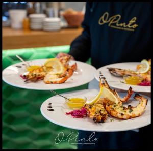 a table with three plates of food on it at Luxury home in Amora
