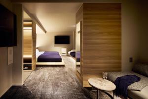 a hotel room with a bed and a tv at Minn Sapporo Odori W18 Station in Sapporo