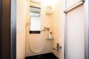 a bathroom with a shower with a sink at Central Shinjuku, Quiet Area, Close to Station, No Stairs, Room101 in Tokyo +12 photos
