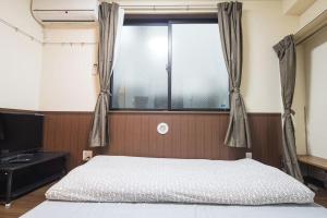 a bedroom with a bed and a large window at Central Shinjuku, Quiet Area, Close to Station, No Stairs, Room101 in Tokyo