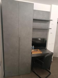 a gray cabinet with a desk in a room at CIVICO 14 Holiday Rooms in Suzzara