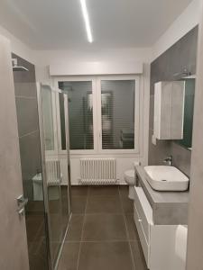 a bathroom with a sink and a toilet and a window at CIVICO 14 Holiday Rooms in Suzzara +39 photos