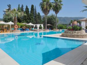 a large swimming pool with blue water at Paloma Blanca in Dassia