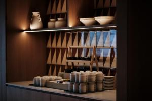 a shelf with bowls and other ceramics on it at Helios Mallorca Hotel & Apartments in Can Pastilla