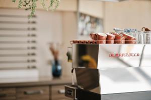a kitchen with a coffee maker with shoes on top at Helios Mallorca Hotel & Apartments in Can Pastilla