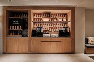 a coffee shop with a display case in a room at Helios Mallorca Hotel & Apartments in Can Pastilla