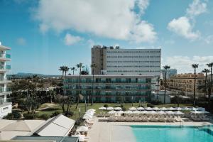 a hotel with a swimming pool and a large building at Helios Mallorca Hotel & Apartments in Can Pastilla