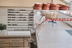 a room with chairs and a wall with writing on it at Helios Mallorca Hotel & Apartments in Can Pastilla