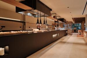 a kitchen with a long counter in a restaurant at Helios Mallorca Hotel & Apartments in Can Pastilla