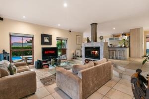 a living room with two couches and a fireplace at Knysna - Views Views Views! in Knysna