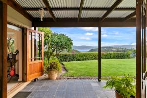 an open door to a patio with a view of a yard at Knysna - Views Views Views! in Knysna