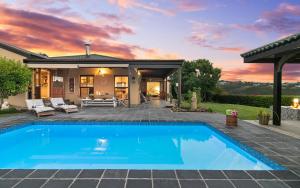 a swimming pool in front of a house at Knysna - Views Views Views! in Knysna