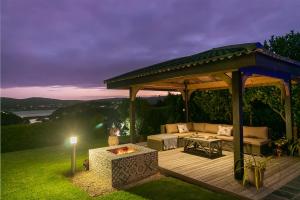 a gazebo with a couch and a fire pit at Knysna - Views Views Views! in Knysna