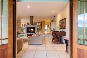 a living room with a fireplace and a couch at Knysna - Views Views Views! in Knysna