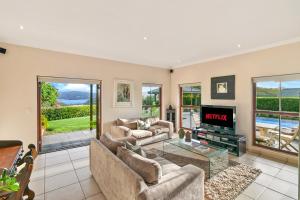 a living room with a couch and a tv at Knysna - Views Views Views! in Knysna