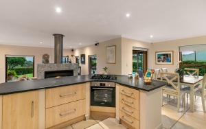 a kitchen with a stove top oven next to a table at Knysna - Views Views Views! in Knysna