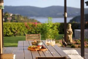 a table with two glasses of wine and a bowl of fruit at Knysna - Views Views Views! in Knysna