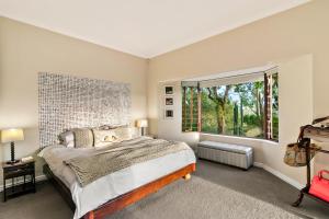 a bedroom with a large bed and a large window at Knysna - Views Views Views! in Knysna