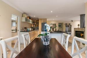 a kitchen and dining room with a wooden table and chairs at Knysna - Views Views Views! in Knysna