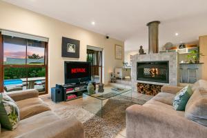 a living room with a couch and a fireplace at Knysna - Views Views Views! in Knysna