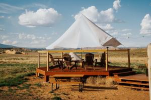 a group of chairs under a tent in the desert at Cozy Glamping Pod for a Nature Escape in Monticello, Utah in Monticello