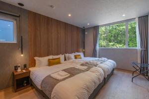 a large bed in a room with a large window at L&R RUSUTSU - Vacation STAY 05027v in Kimobetsu
