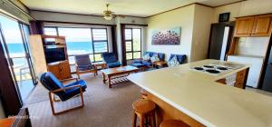 a kitchen and living room with a view of the ocean at Serene Shores - Sleeps 8 in Margate