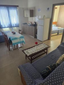 a living room with a table and a kitchen at Eleni Apartments in Ayia Napa